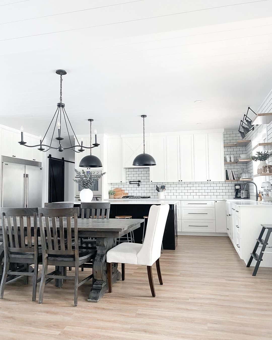 Black Pendant Lights Define Kitchen Island Zones