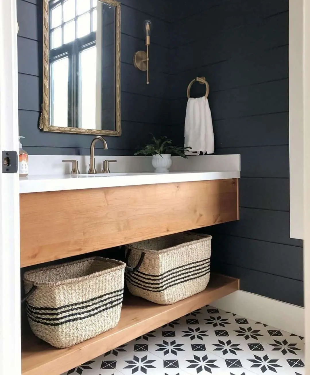 Woven Baskets With Black Stripes Add Natural Texture Below Vanity
