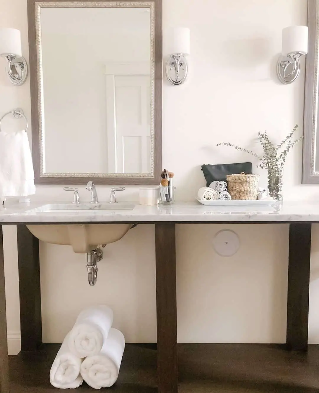Textured Gray Mirrors and Chrome Sconces Above Marble