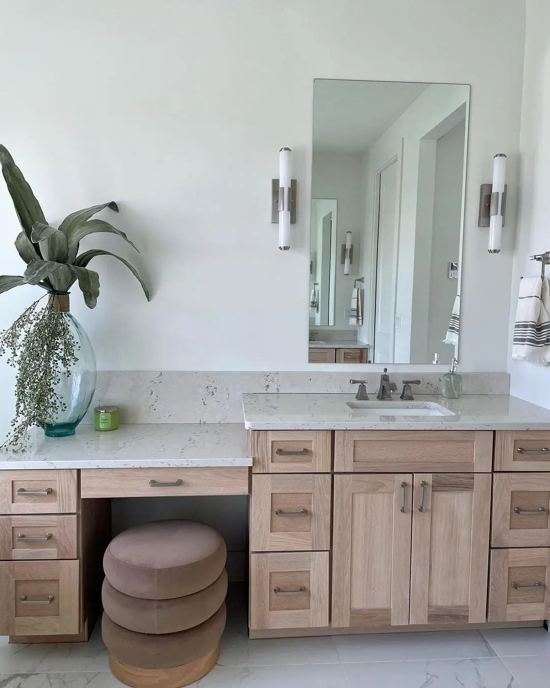 Vertical Tube Sconces with Brushed Nickel Frame a Tall Mirror