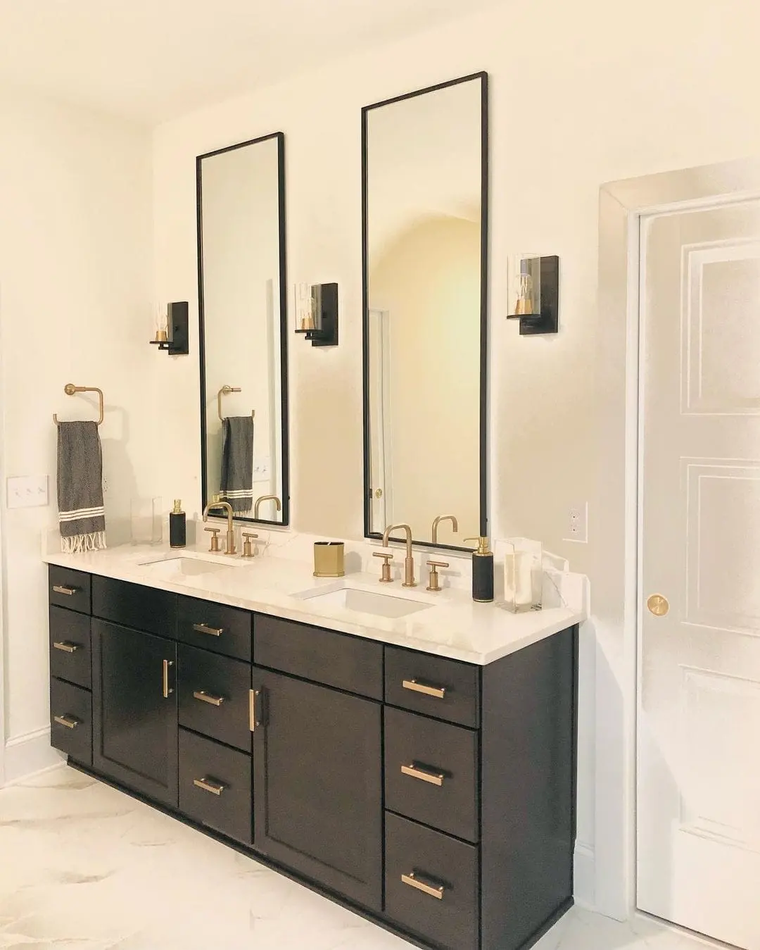 Maximize Vertical Space with Tall Black Mirrors and Minimalist Sconces