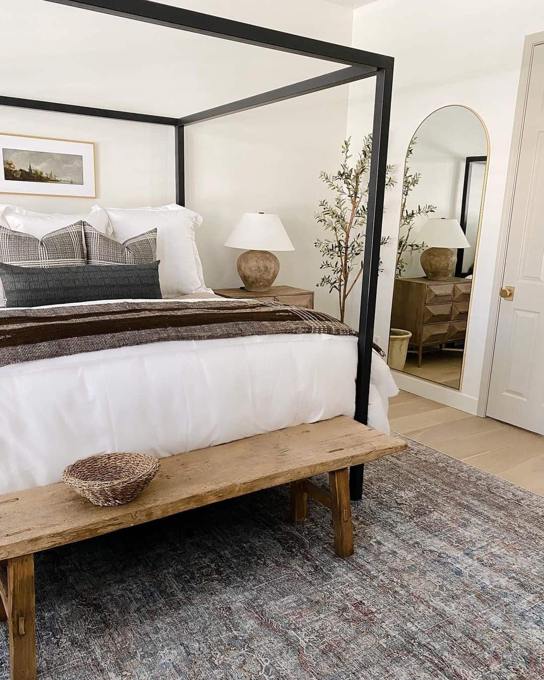 Tall Arched Mirror Reflects a Dresser and Creates Depth