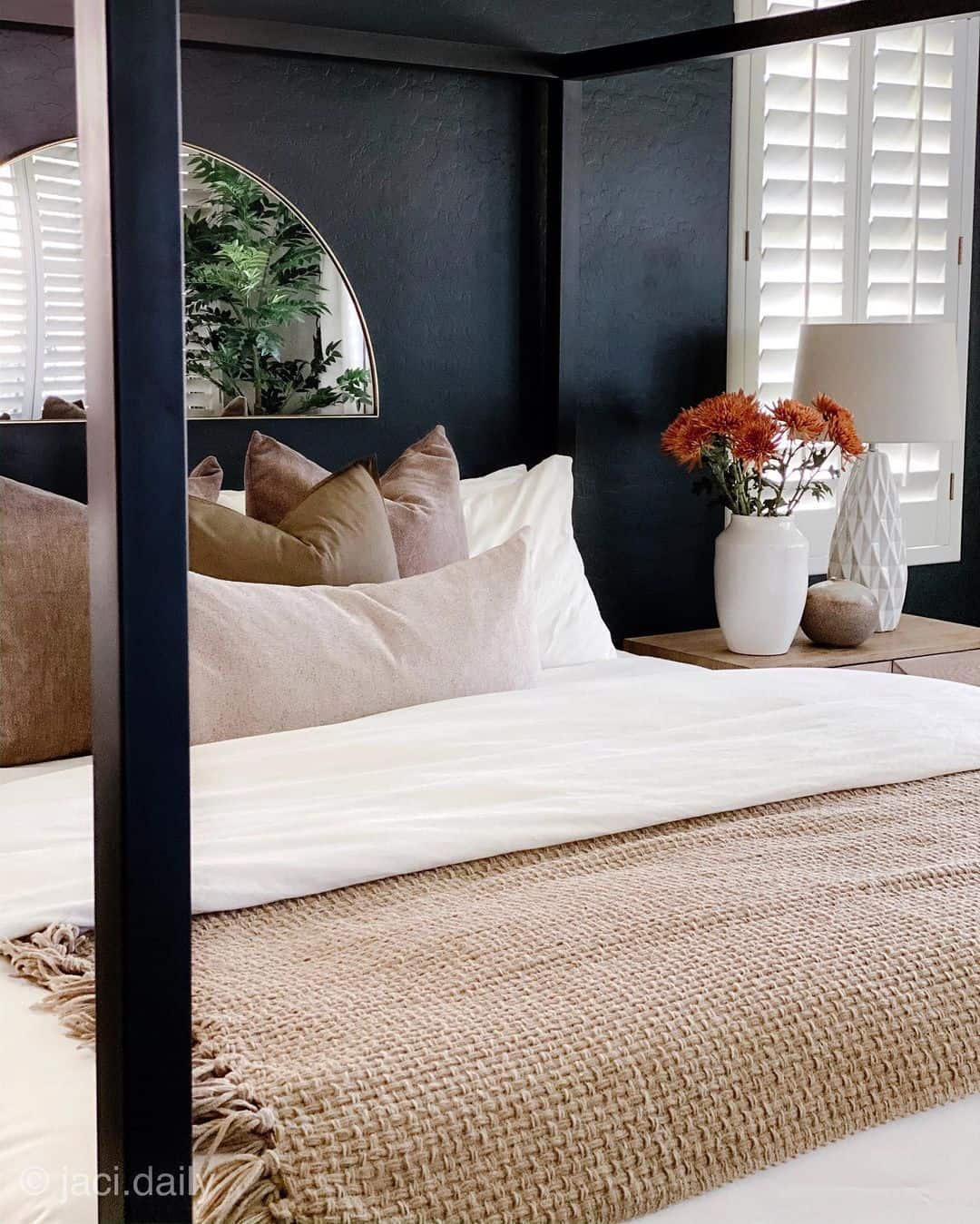 Arched Mirror Reflects Greenery and Shutters