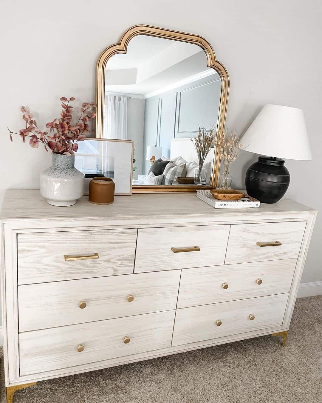 Ornate Gold Mirror Accents a Light Wood Dresser