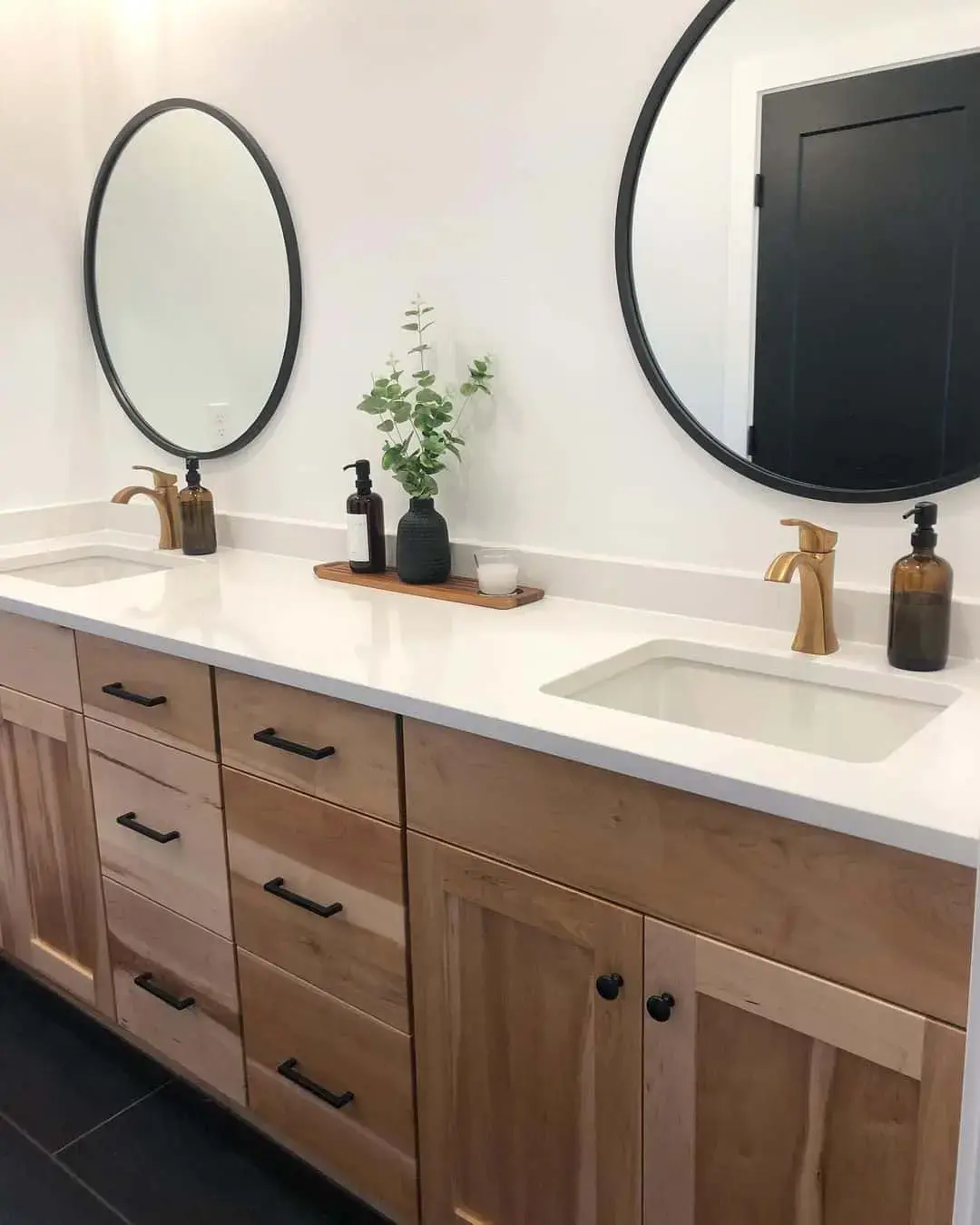 Round Black Mirrors Add Warmth to a Double Vanity