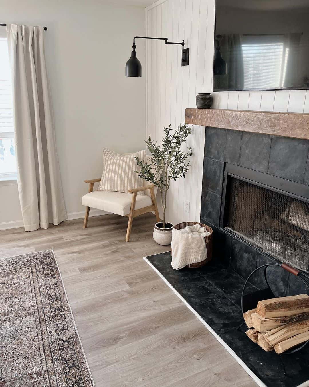 Juxtapose a Rustic Wood Mantel with a Black Tile Fireplace
