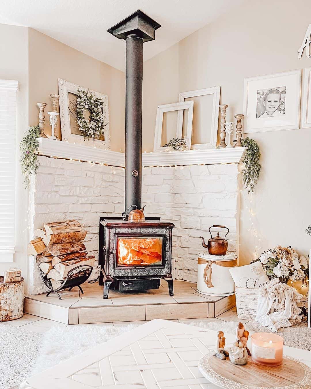 White Brick Fireplace with Rustic Wood Accents and Twinkle Lights
