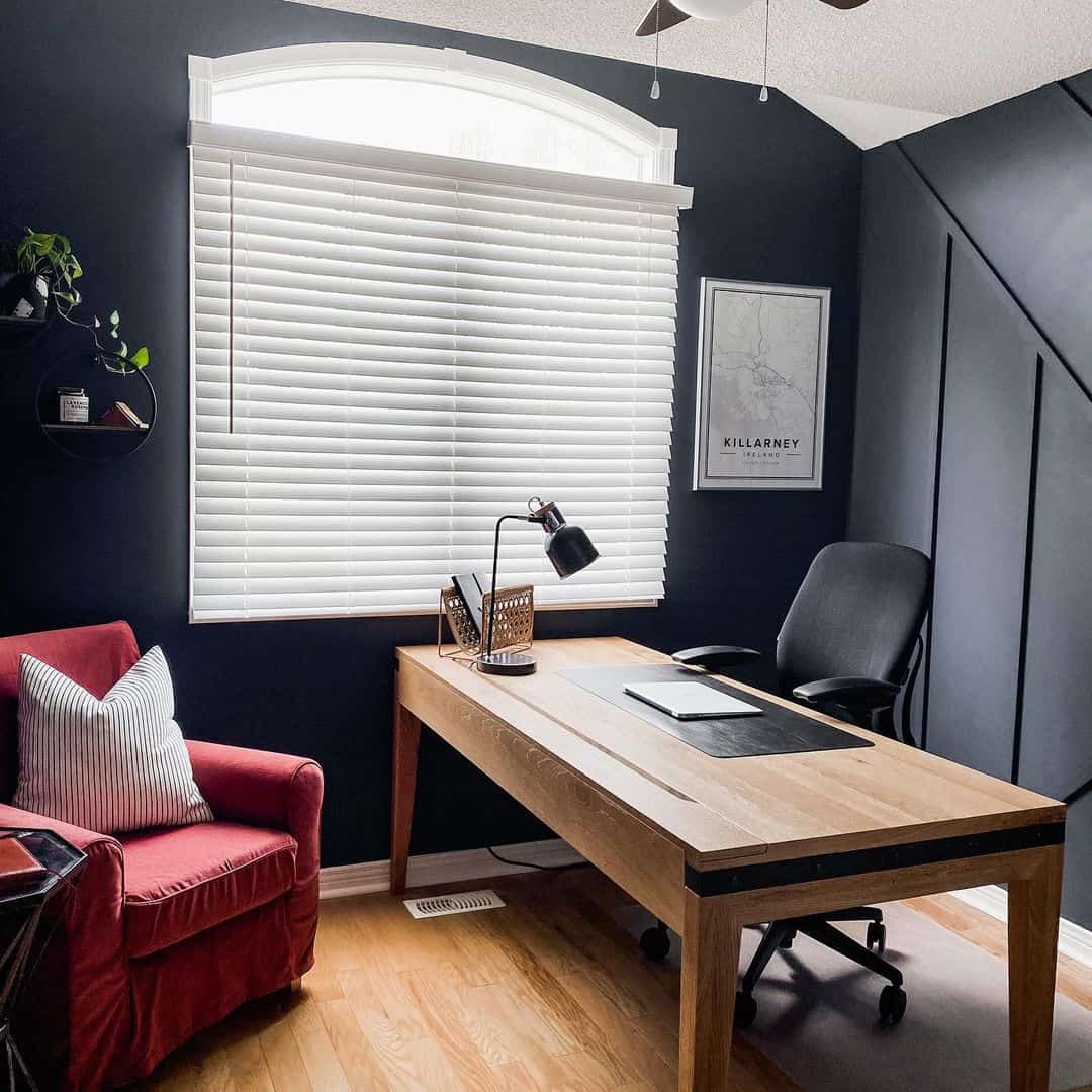 Geometric Black Wall Panels Add Architectural Depth Behind the Desk
