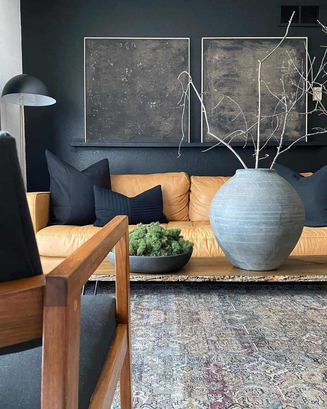 Abstract Art Pieces Add Moody Texture Above a Black Wall