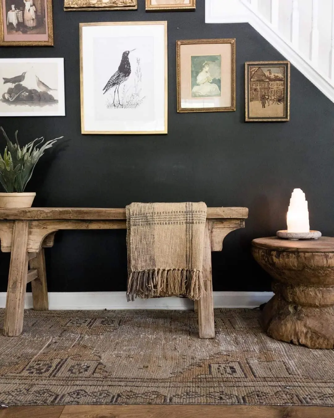 Gallery Wall of Vintage Prints Adds Character Above a Bench