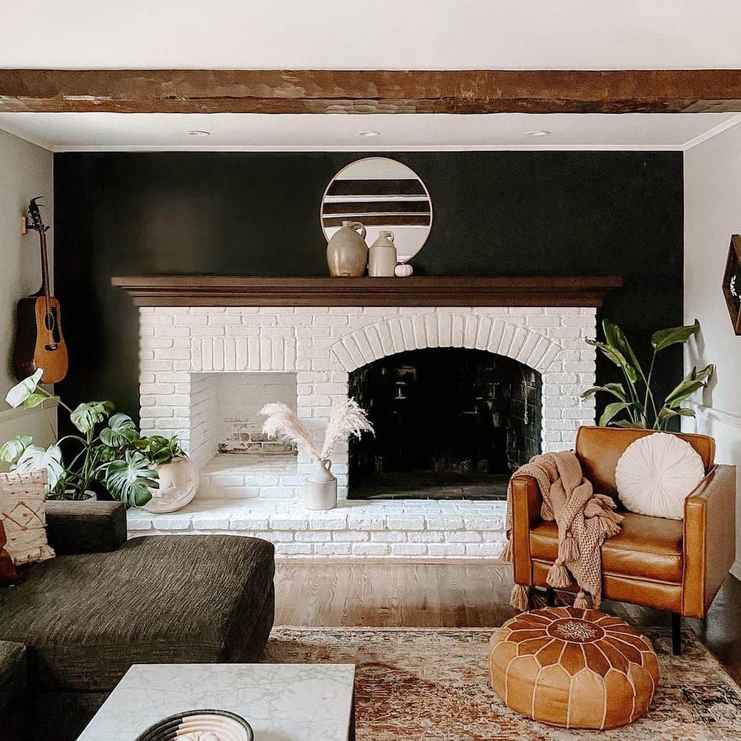 Round Mirror Adds Graphic Interest Above Black Wall