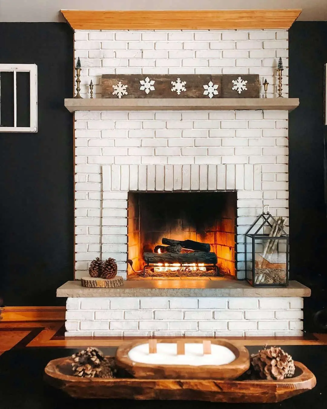 Black Wall Accents a White Brick Fireplace