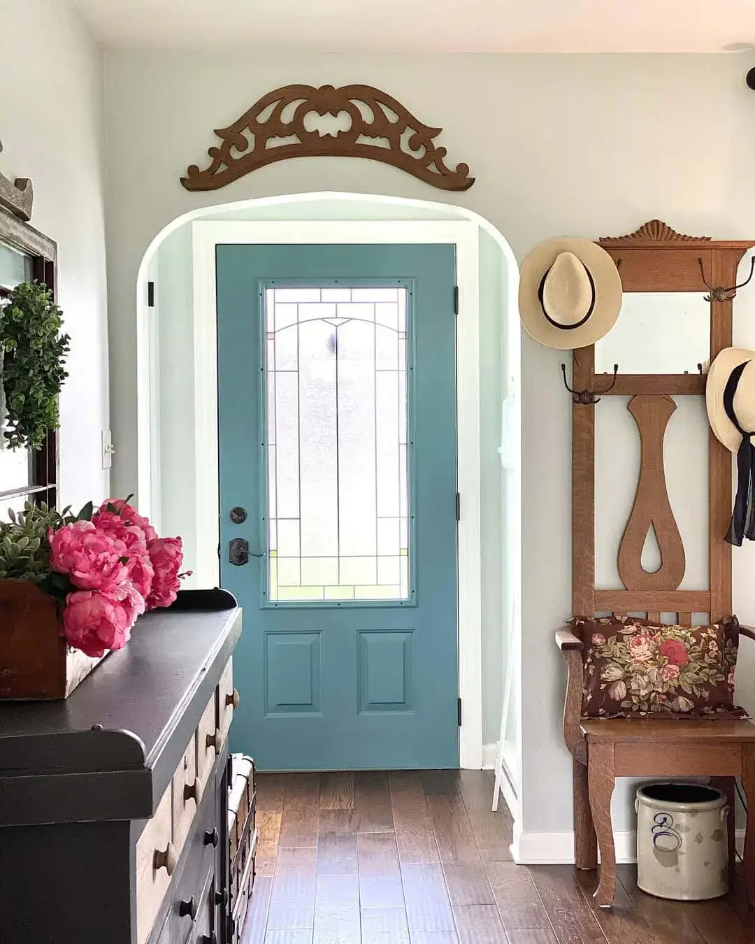 Ornate Wood Archway Adds Architectural Detail Above Blue Door