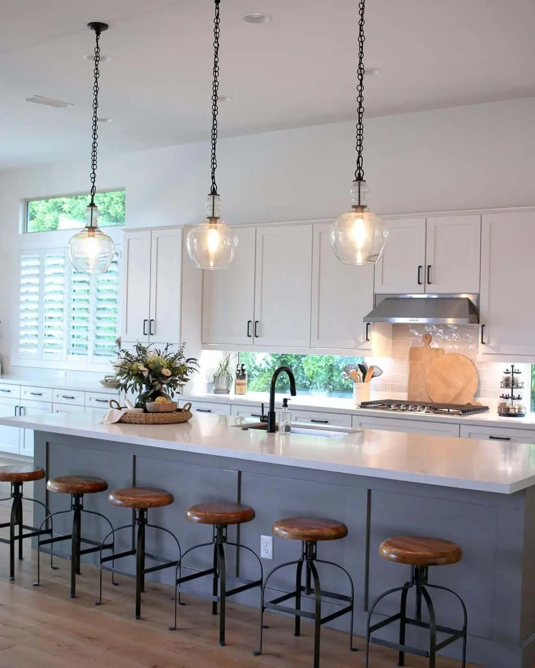 Gray Island with Industrial Stools and Clear Glass Pendants