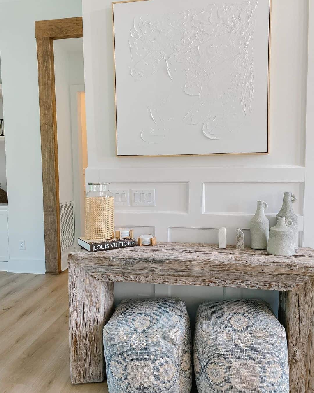 Rustic Beam Console Table with Layered Books and Vases