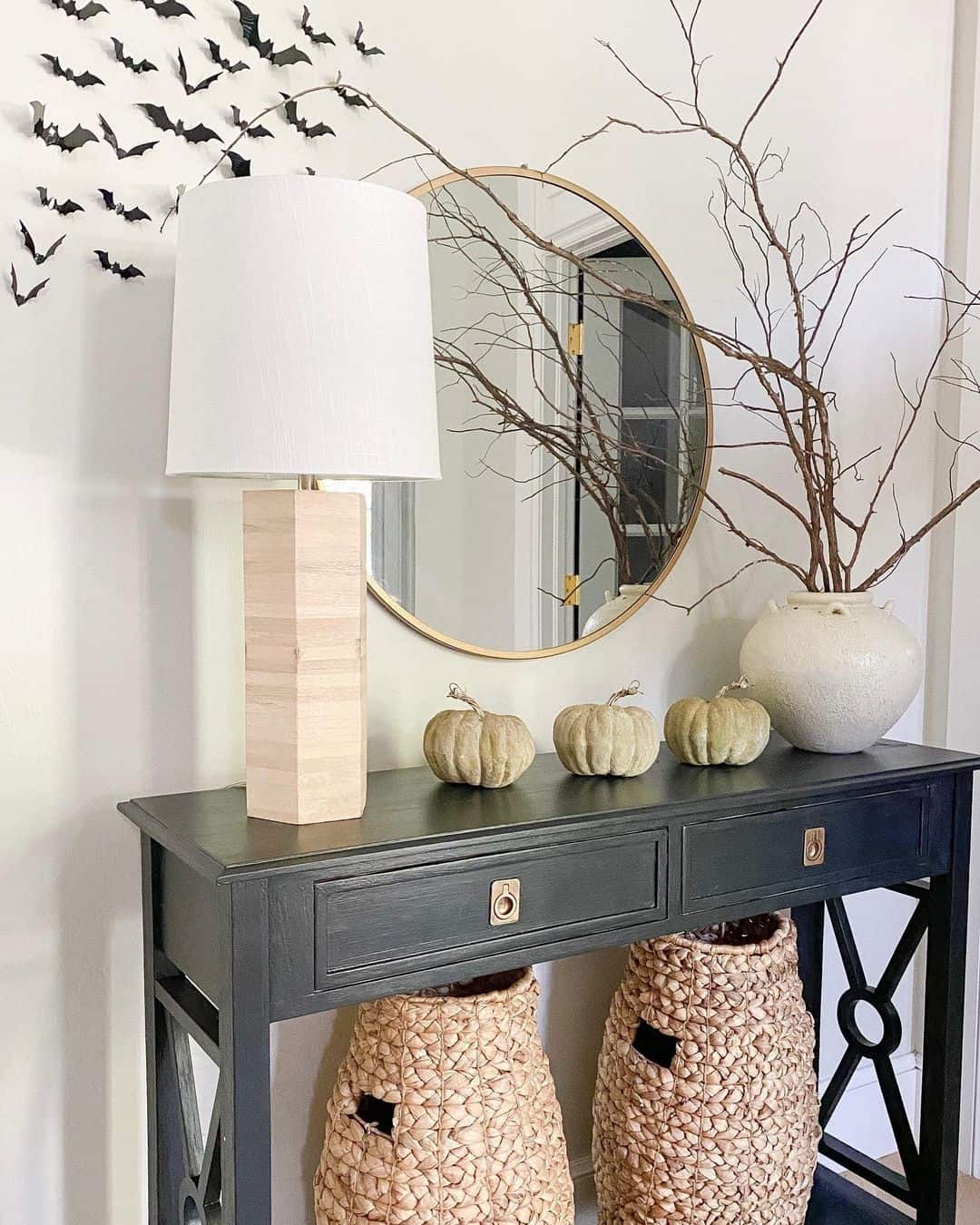 Gold Mirror Reflecting Branches and Pumpkins