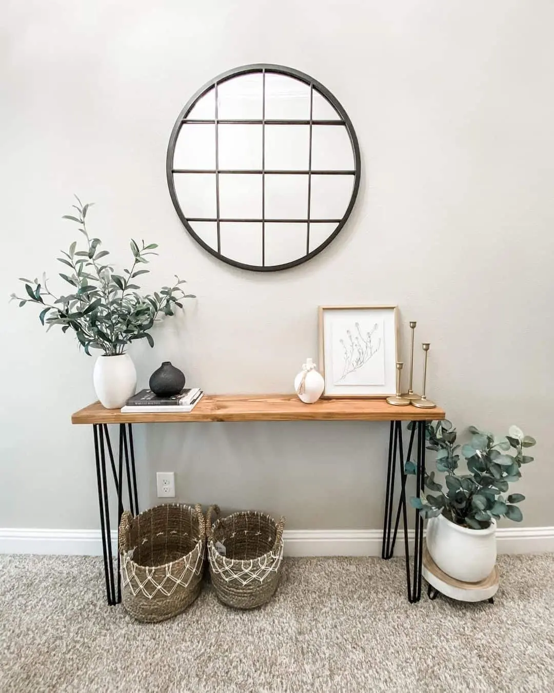 Round Grid Mirror Above Botanical Art