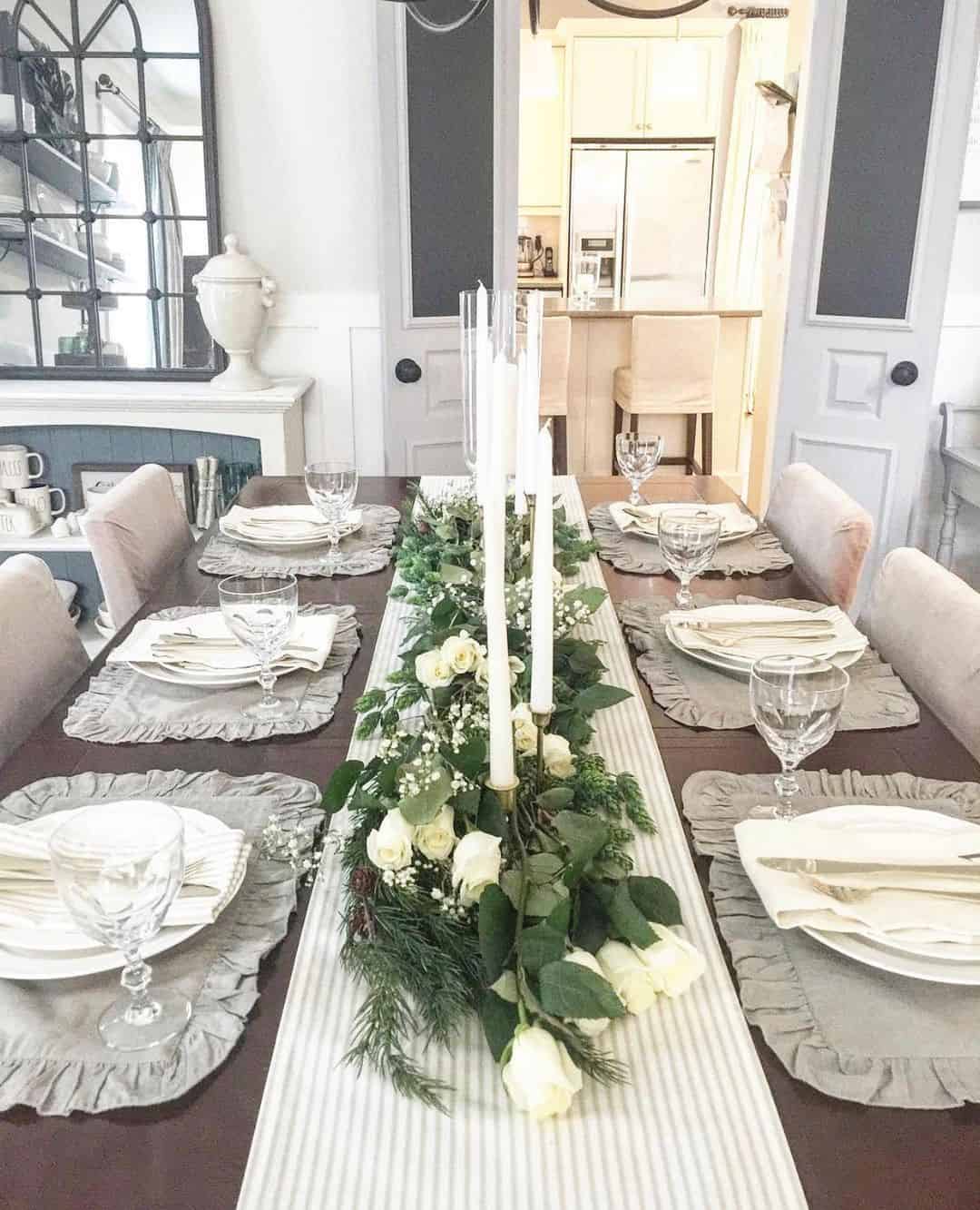 Tall Glass Candle Holders Amidst a Floral Runner