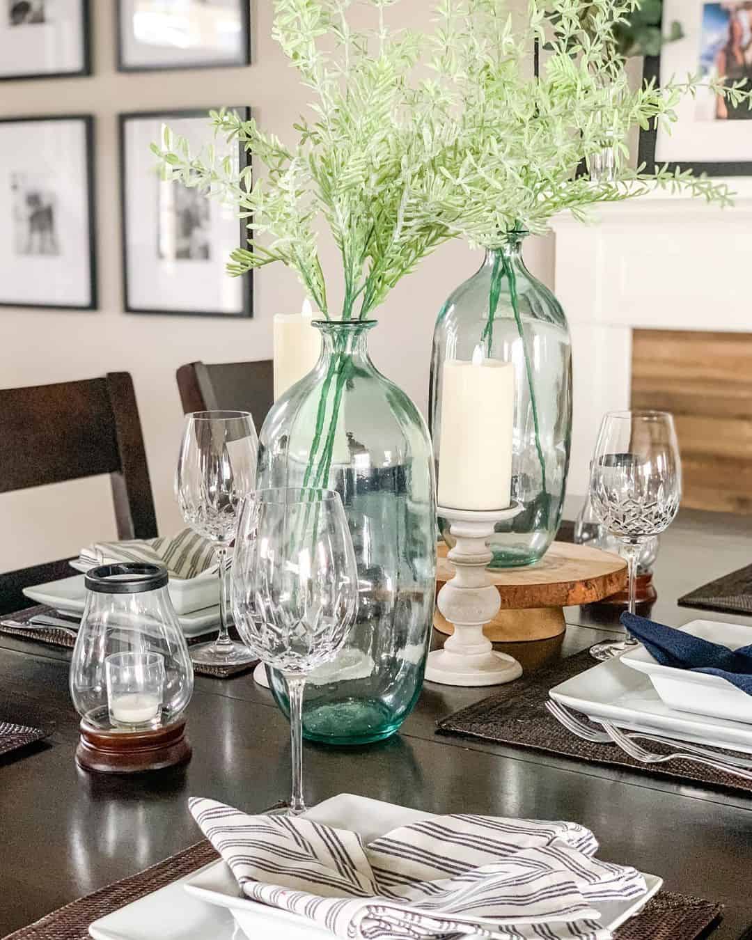 Glass Bottles With Greenery and Candles Create a Natural Focal Point