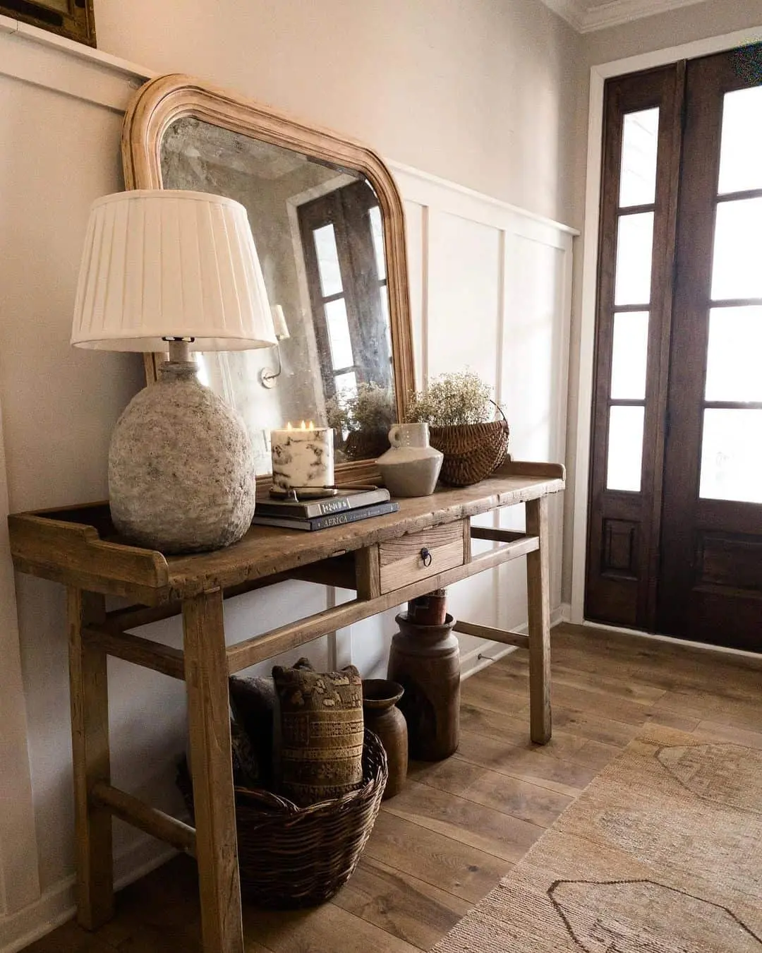 Rustic Charm: Curved-Top Mirror Above Wooden Console