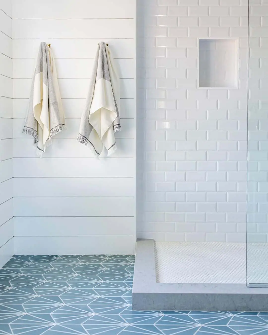 Geometric Floor Tiles Ground the White Subway Tile Shower