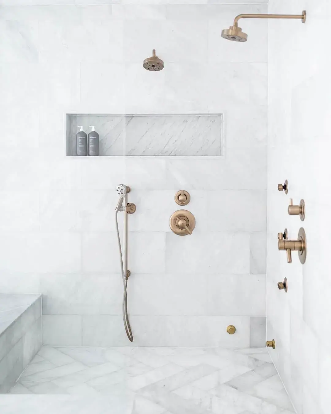 Marble Niche Backed With Herringbone Tile Creates a Luxe Shower Display