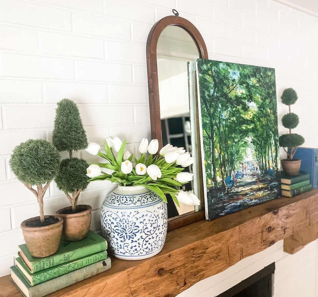 Layered Topiary Trees Add Vertical Interest to Mantel