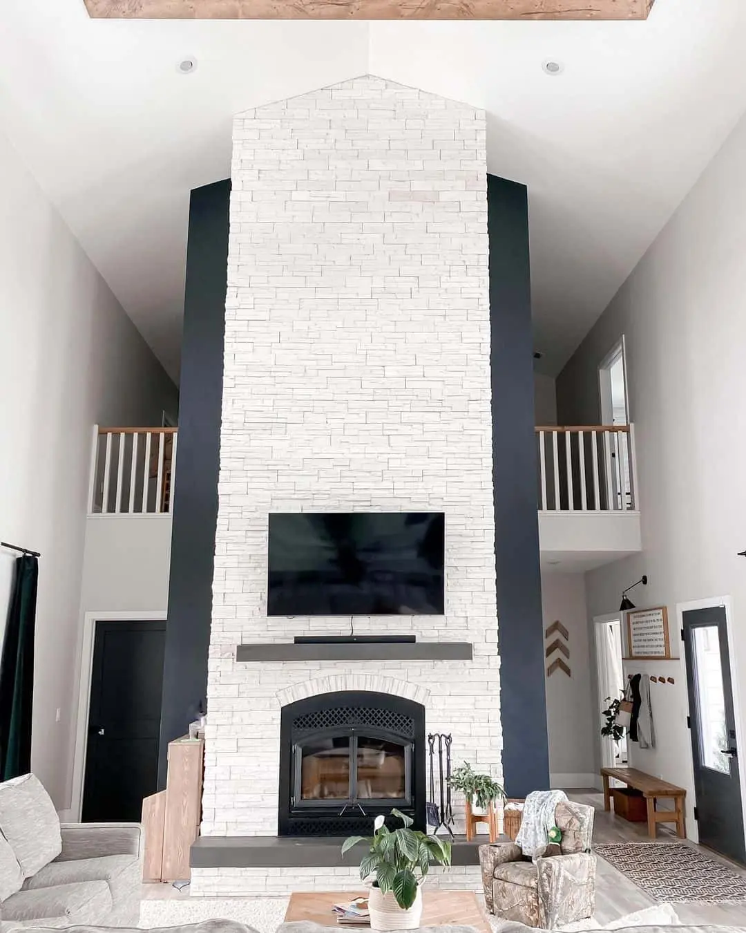 Stacked Stone Fireplace with Navy Panels and Central TV