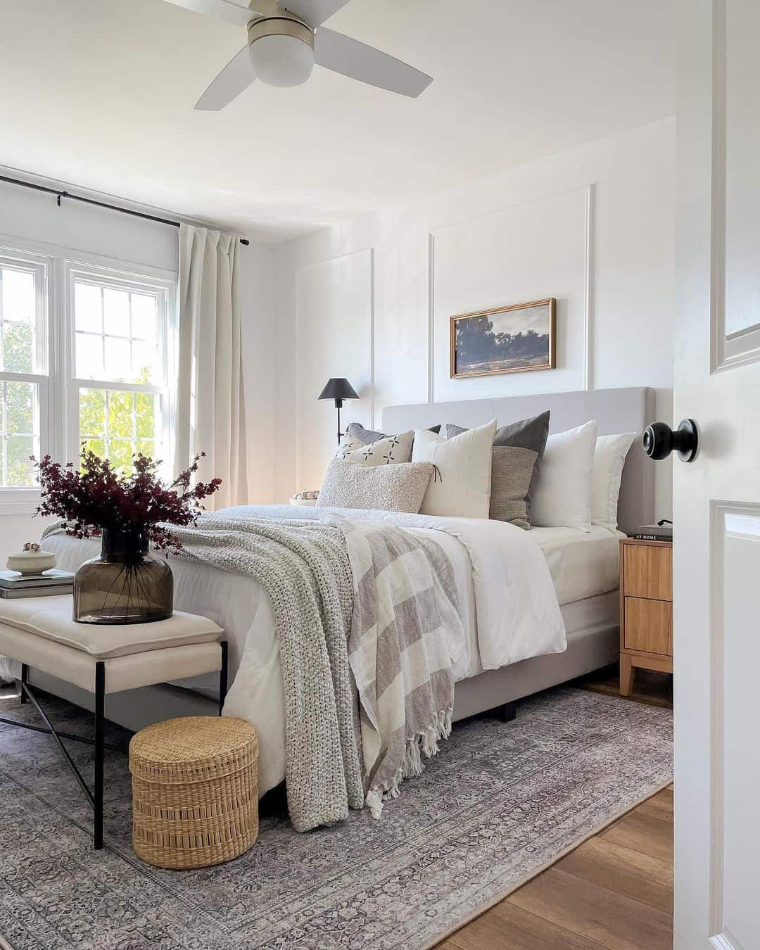 Creamy curtains frame windows with natural light
