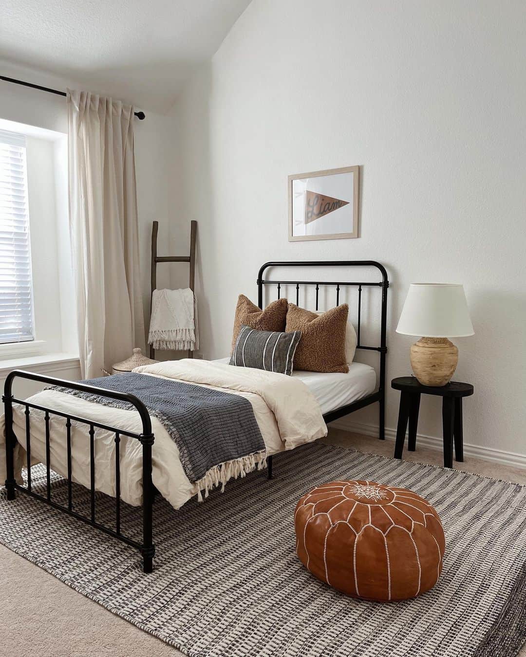 Cream Curtains Frame a Cozy Bedroom With a Ladder Shelf