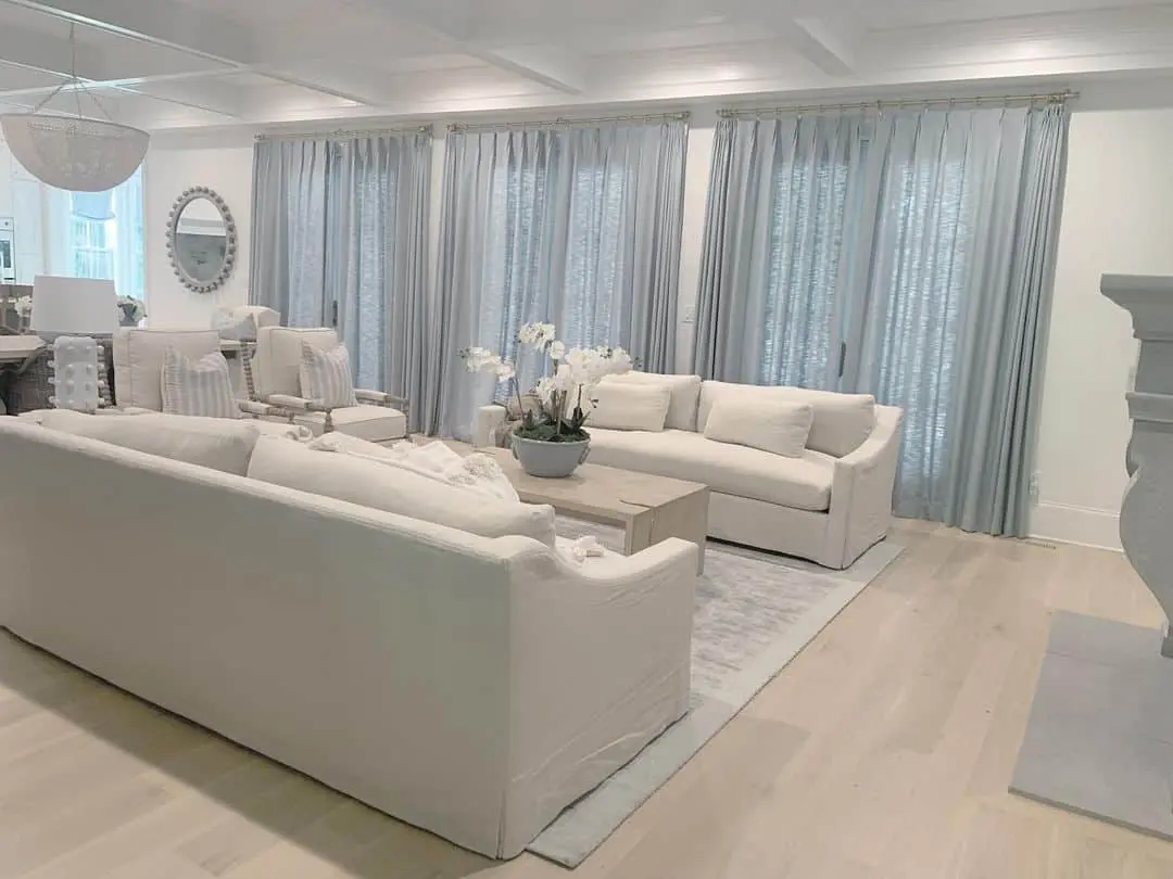 Soft Blue Curtains Frame the Windows with Subtle Texture