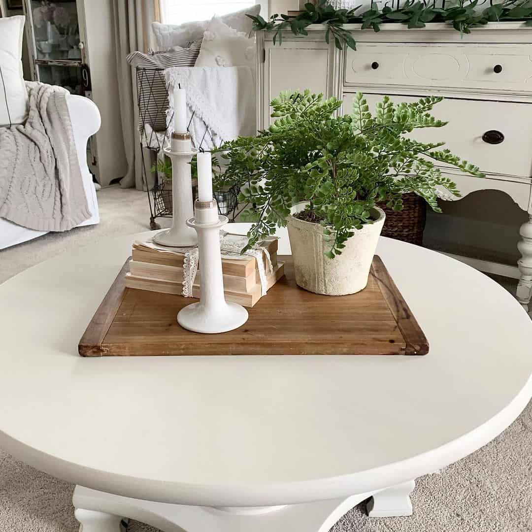 Candlesticks Stacked with Books and a Potted Fern