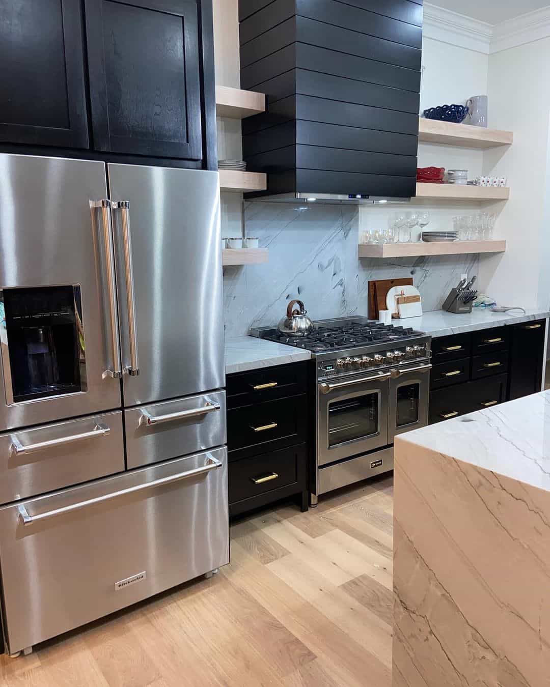 Light Wood Floors Complement Black and Marble Kitchen