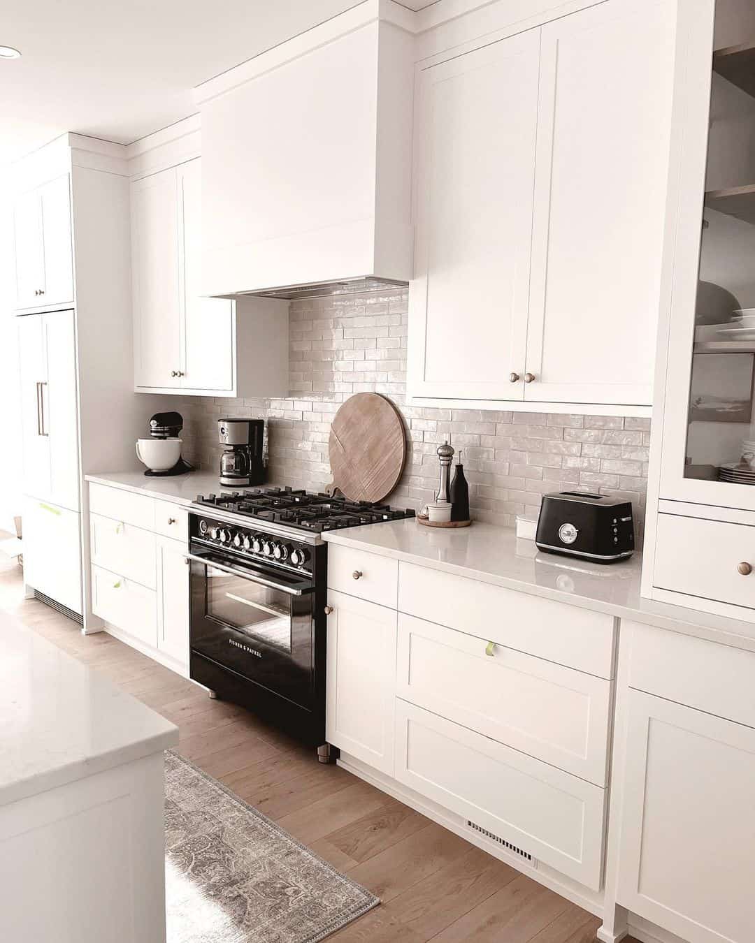 Wood Plank Flooring Grounds a Bright White Kitchen