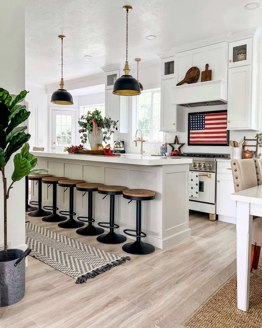 Black Pendant Lights with Gold Accents Define Island Zones