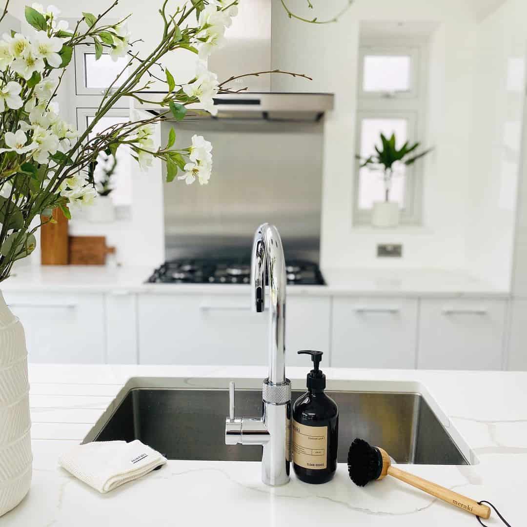 Dark Soap Dispenser and Wooden Brush by the Sink