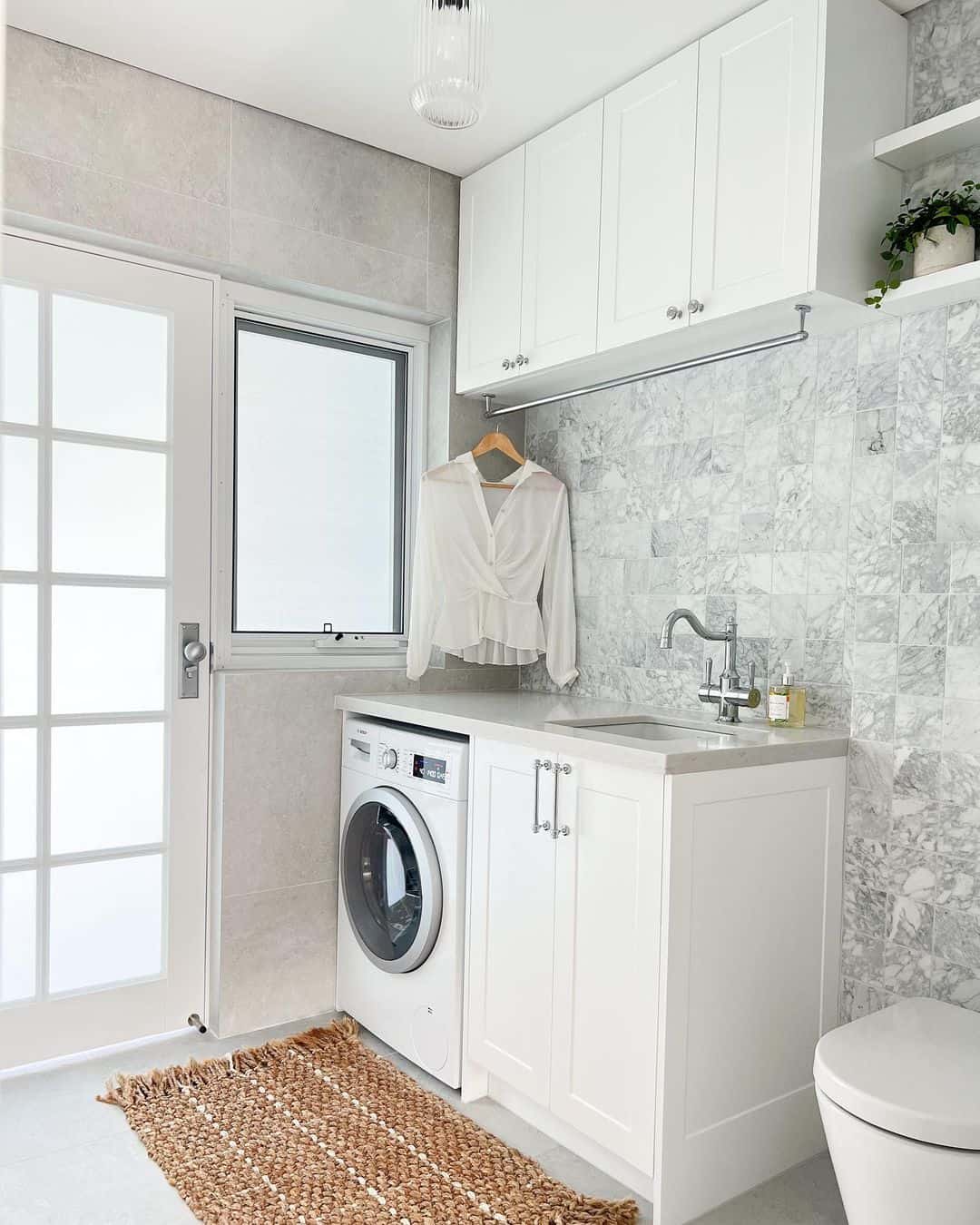 White Blouse Drapes on a Clothes Rail for Air Drying