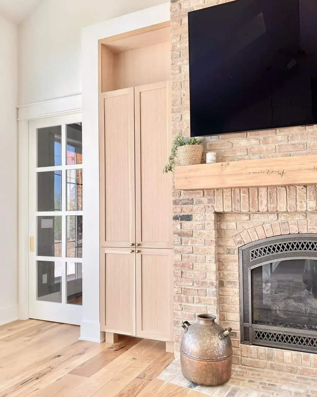 Minimalist Wood Cabinet Balances Limewash Brick Fireplace