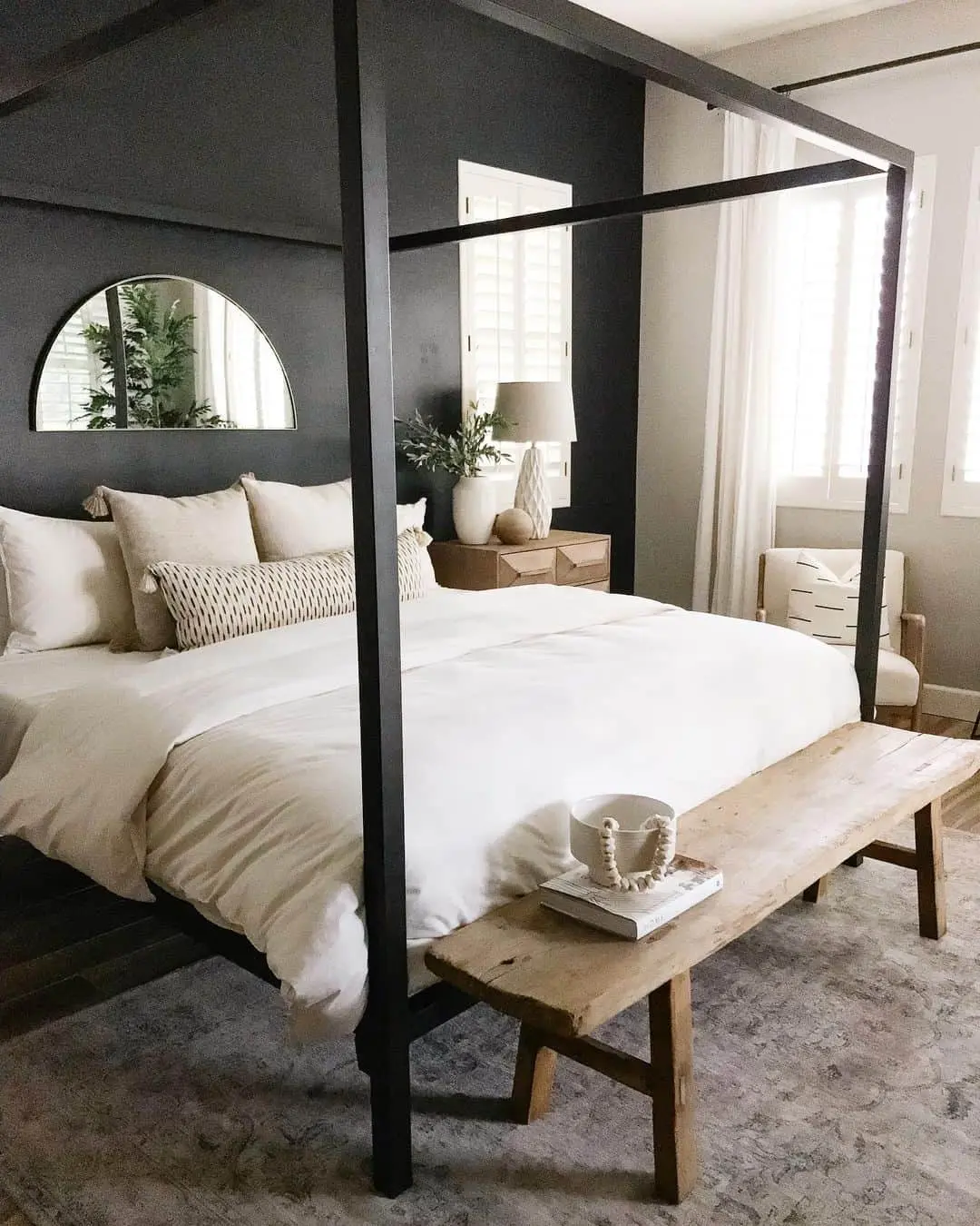 Half-Circle Mirror Reflects Greenery Above Dark Walls