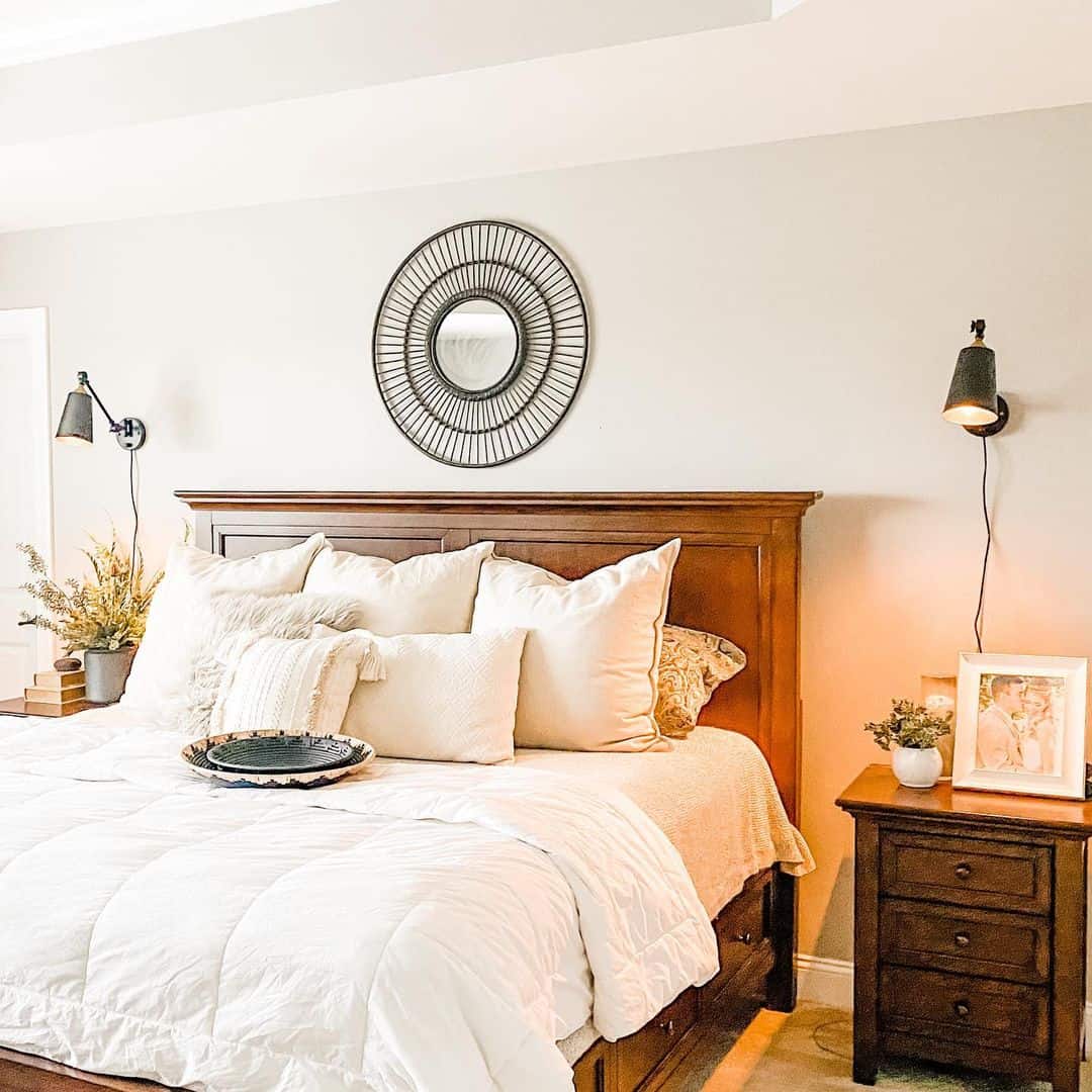 Round Metal Mirror Adds Graphic Interest Above Bed