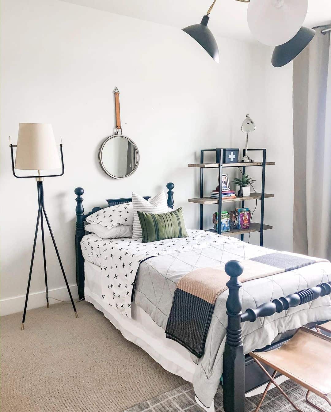 Round Mirror with Leather Strap Hung Above Bed