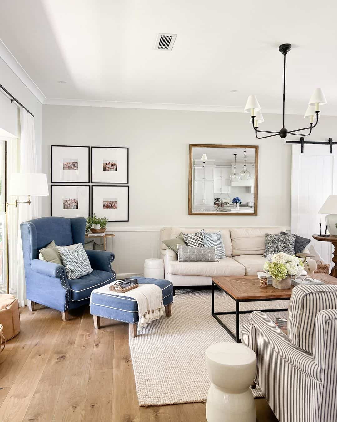 Square Mirror Reflects Kitchen View Above Sofa