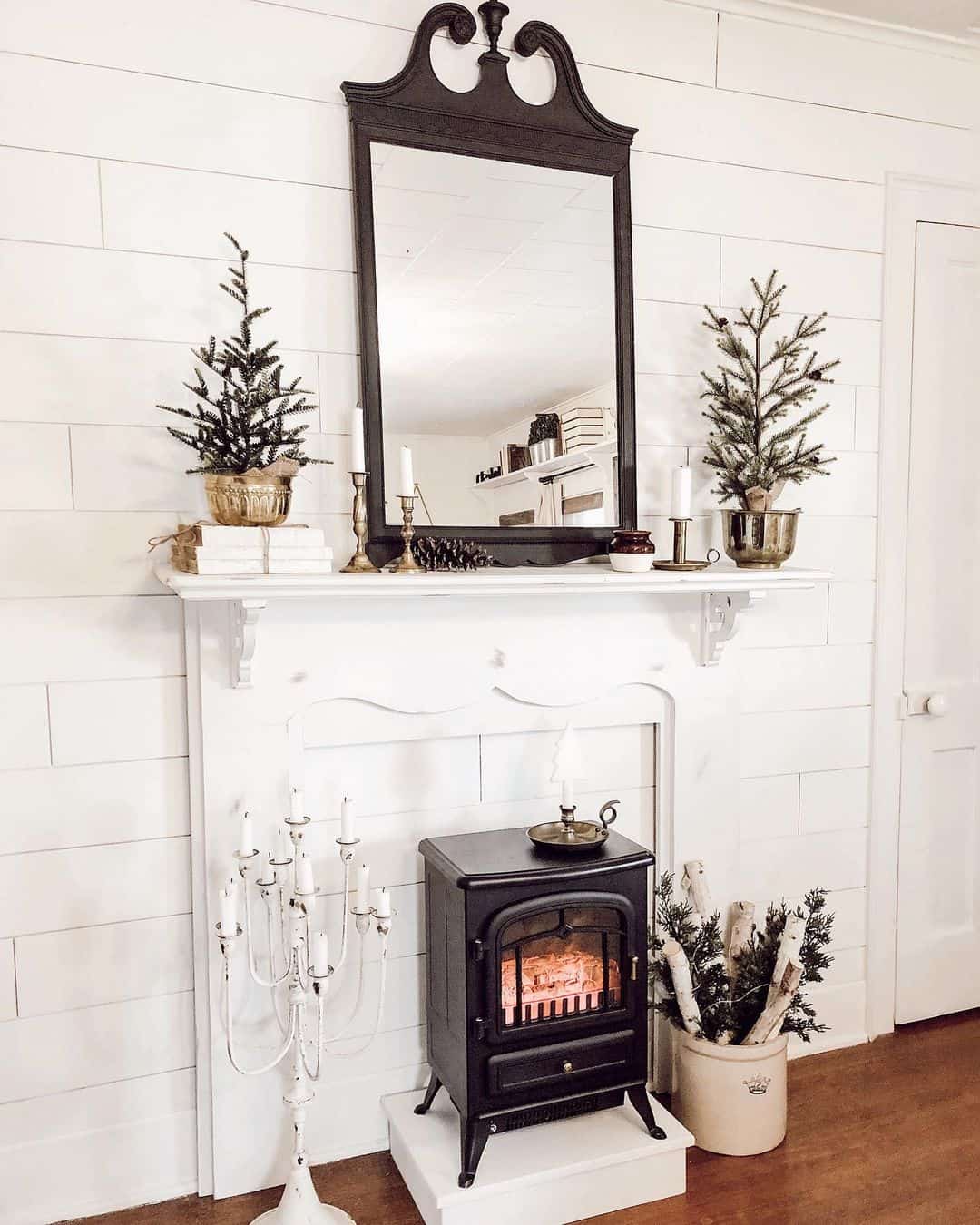 Tall Black Mirror Frames a Layered Mantel Vignette