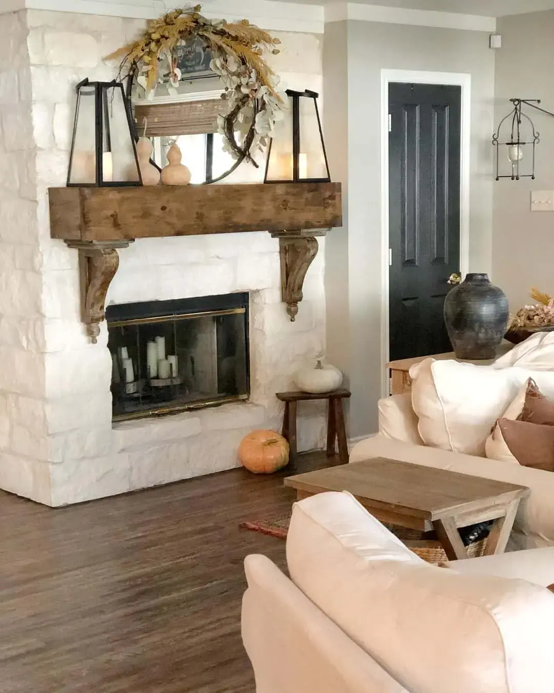 Lanterns Flank a Rustic Wood Mantel for Cozy Ambiance