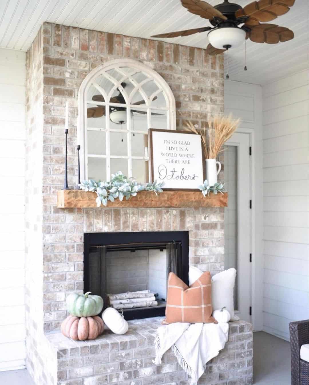 Arched Windowpane Mirror Frames a Seasonal Mantel Display