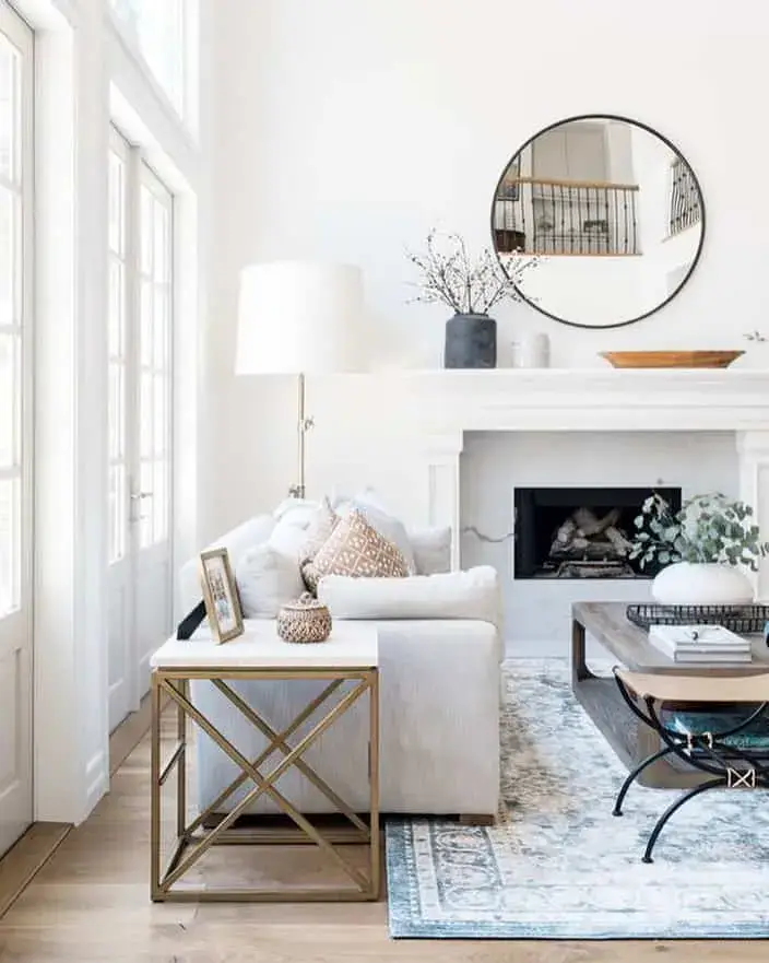 Simple Round Mirror Anchors Mantel with Black Frame
