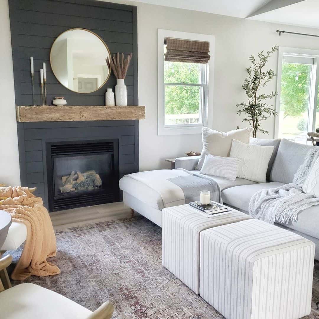Simple Round Mirror Reflects Warmth From Wood Mantel