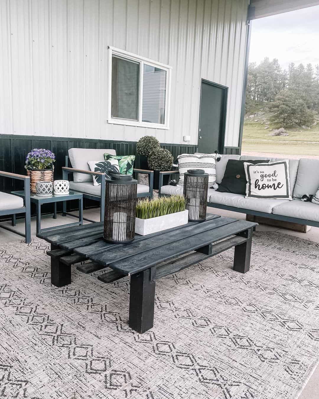 Dark Pallet Coffee Table Holds Lanterns and Greenery