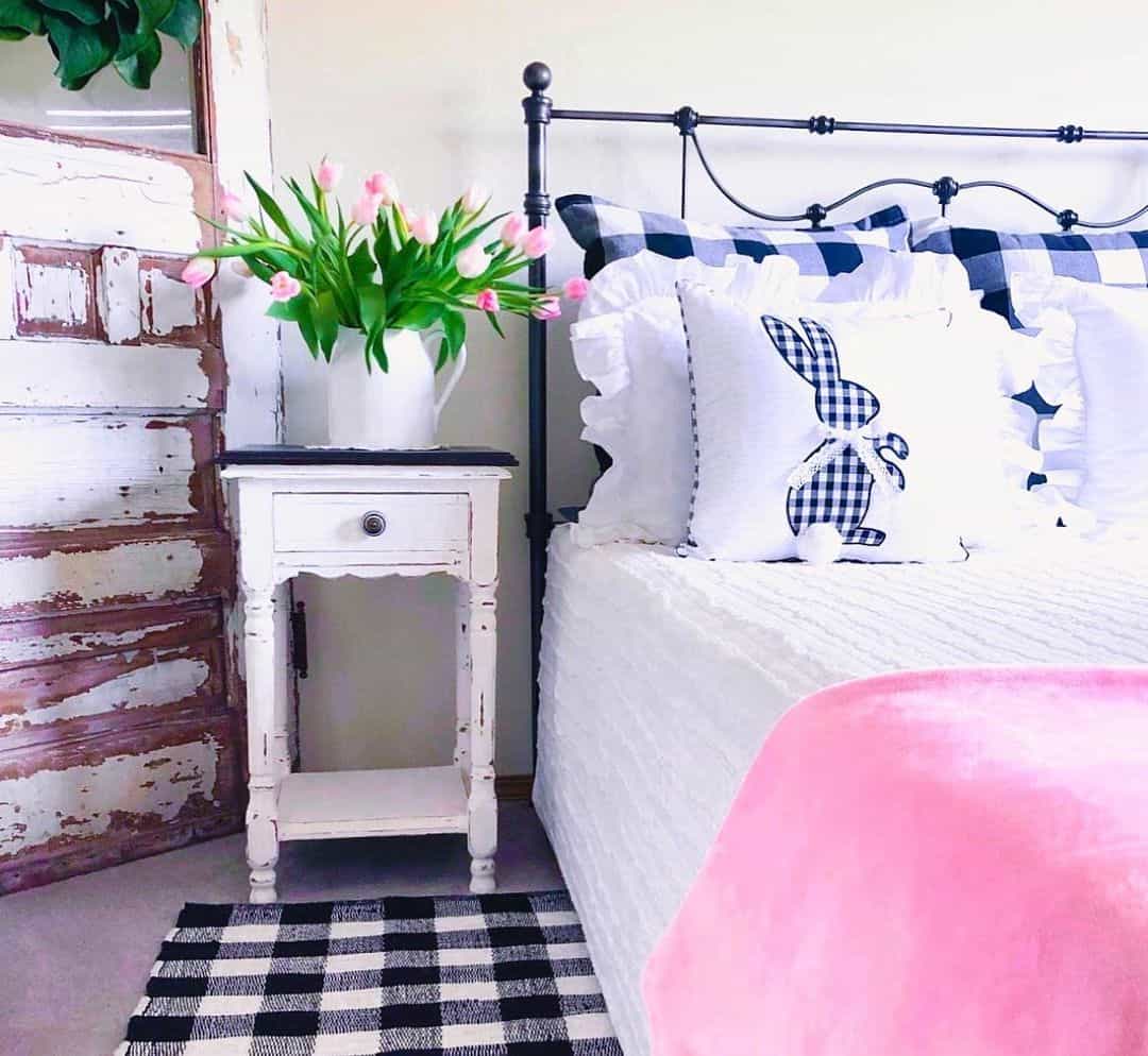 Distressed nightstand holds pink tulips
