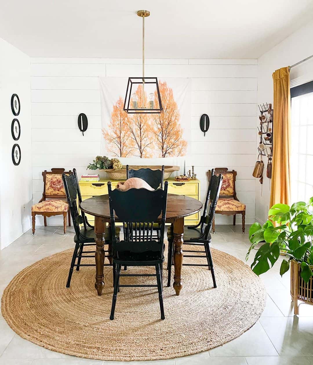 Round Jute Rug Under Dark Wood Table With Black Chairs